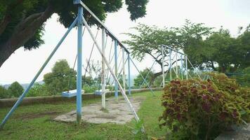 Empty swing on the play ground kids, when corona virus is spread out. The footage is suitable to use for child play ground content media. video