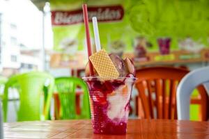 Traditional sweet water ice with fruits called cholado in the city of Cali in Colombia photo