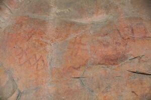 Prehistoric paintings on rock known as petroglyphs in Colombia photo