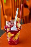 Traditional sweet water ice with fruits called cholado in the city of Cali in Colombia photo