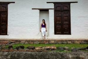 Beautiful young woman at the historical La Merced Church located in the Cali city downtown in Colombia photo