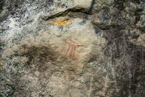 Prehistoric paintings on rock known as petroglyphs in Colombia photo