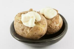 Traditional Colombian cooked potatoes called papas saladas topped with mayonnaise isolated on white background photo