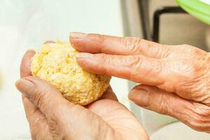 Traditional Colombian Arepa de Choclo Preparation. Form corn dough into medium sized balls photo