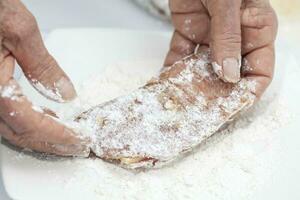 Breading a cordon bleu. Adding flour photo