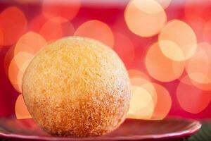 Traditional Colombian bunuelos. Deep Fried Cheese Bread on christmas red background photo