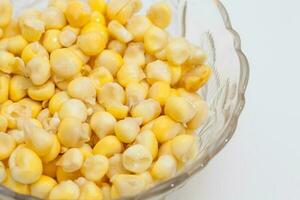 Traditional Colombian Arepa de Choclo Preparation. Transparent bowl filled with corn kernels. photo