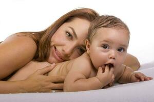 Happy beautiful young mother and her baby girl on white background photo