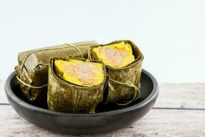 Traditional Colombian tamale as made on Santander region isolated on white background photo