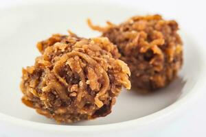 Colombian traditional coconut sweet called cocada in a white ceramic dish photo