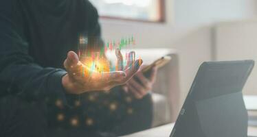 investment financial strategy concept, man holding  virtual trading graph and working with smartphone and tablet, stock market trading, cryptocurrency exchange, fund for future photo