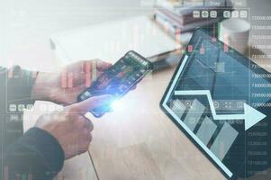 financial investment concept, businessman working on computer tablet and smartphone with virtual trading graph in concept of investment business growth and marketing photo