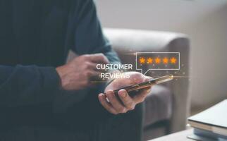 customer service survey feedback concept, businessman using smartphone give review and five stars rating to business services photo