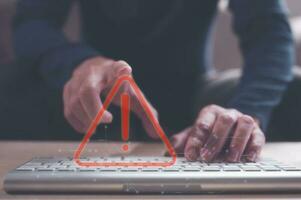 internet network security concept, businessman typing on computer laptop keyboard with triangle, warning sign , developer with triangle caution warning sign for notification error, maintenance concept photo