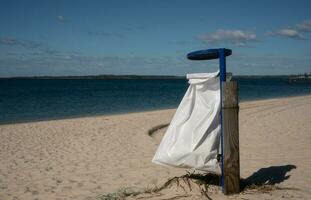 cleaning day earth day concept, Garbage container from a garbage bag on the beach photo