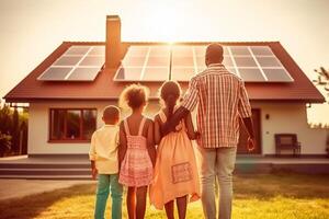 Rear view of african american father and kids front house with solar panels. . photo