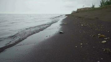 Small sea wave with black sand, calm and relax vibes. Take with low angel.  The footage is suitable to use for relaxion video background and travel content media.