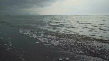 Small sea wave with black sand, calm and relax vibes. Take with low angel.  The footage is suitable to use for relaxion video background and travel content media.