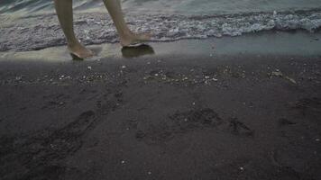 Man walk over the sea sand with sea wave. The footage is suitable to use for relaxion video background and travel content media.