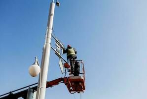 two workers change road signs photo