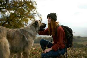 woman playing with dog outdoors travel friendship together photo