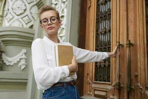 student with a book in his hands outdoors reading Lifestyle photo