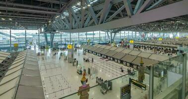 June 2,2022 Bangkok,Thailand timelapse view inside departure terminal with many passenger at check-in counter. suvarnabhumi airport thailand reopening country video