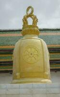 golden bell at Wat Rakhang Kositaram Woramahawihan, an important tourist attraction of Thailand. Closeup photo