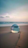 A Mirror On The Beach With The Sun Setting Behind It photo