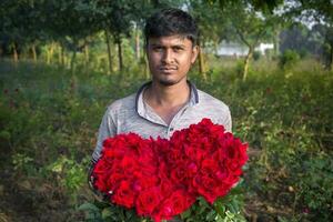 Bangladesh December 07, 2017 A flower farmer in a village called Golap Gram near Dhaka is picking flowers from his garden to sell at Savar, Dhaka. photo