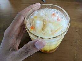 Yakult mango ice with fresh milk and little pulpy. The photo is suitable to use for coffee shop background, menu poster and coffee content media.