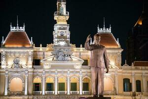 Ho Chi Minh City, Vietnam- DEC 10, 2016. The former city hall of Saigon was built during the French colonial period.Today it houses government offices. A statue of Ho Chi Minh stands in front. photo