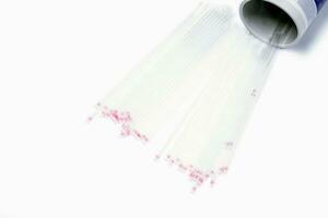 Top view and crop of medical capillary glass tube spread and container on white background., Designed for both safe blood collection as well as accurate micro-hematocrit determinations Precision. photo