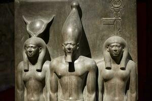 Cairo, Egypt , March 18, 2023  Statue of King Menkaura, goddess Hathor and Bat. The Egyptian Museum in Cairo. photo