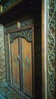 Javanese traditional door with carved carvings made of wood photo