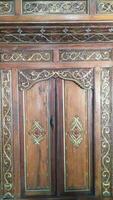 Javanese traditional door with carved carvings made of wood photo