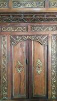 Javanese traditional door with carved carvings made of wood photo