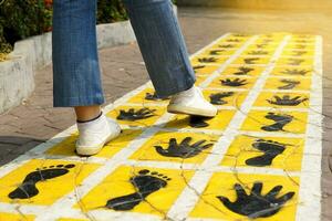 Follow the footsteps marked on the walkway compare footsteps It is a record of the virtue of a person who struggled. Overcome obstacles straight forward leaving traces for others to see and remember. photo