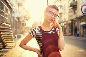 pretty woman outdoors wearing glasses glass with drink walk photo