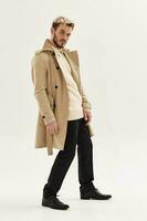 handsome man trendy hairstyles autumn style coat posing photo