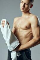 athletic man with towel in hands pumped up press gym lifestyle photo