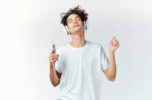 emotional man in white t-shirt listening to music with headphones cropped view photo