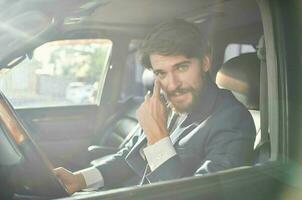 businessmen in a suit in a car a trip to work self confidence photo