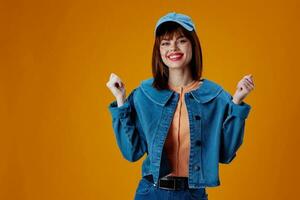 Beauty Fashion woman in a cap and denim jacket posing color background unaltered photo