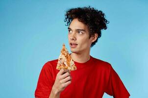Young man eating pizza photo