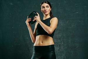 sports woman slim figure workout dark background photo