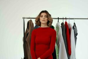 cheerful woman in a red jacket near the wardrobe isolated background photo