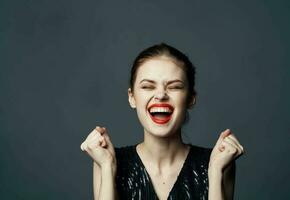 Energetic woman in black dress gestures with hands emotions model surprise delight photo