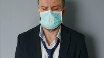 Pandemic protection of the Covid-19 coronavirus. Tired caucasian man in a protective medical mask. Concept impact of the pandemic - unemployment, poverty, disease video