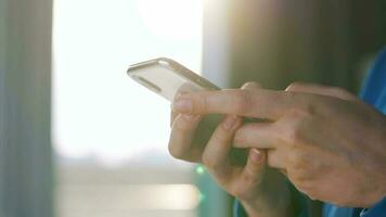 Female hands using smartphone against the setting sun video